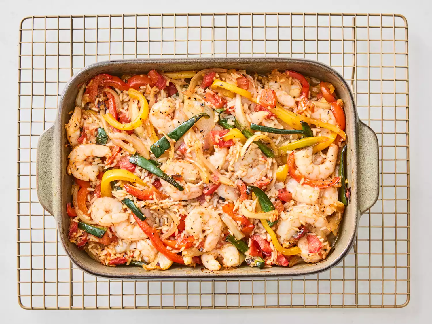 Shrimp fajita rice casserole in a baking dish on a cooling rack