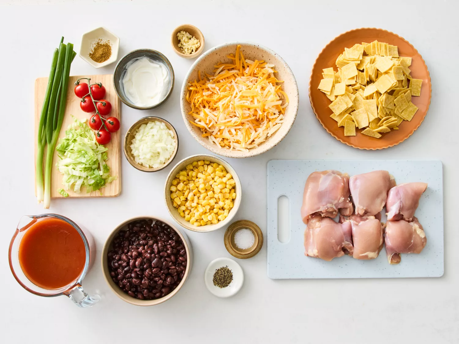Ingredients for chicken enchilada casserole arranged on a countertop