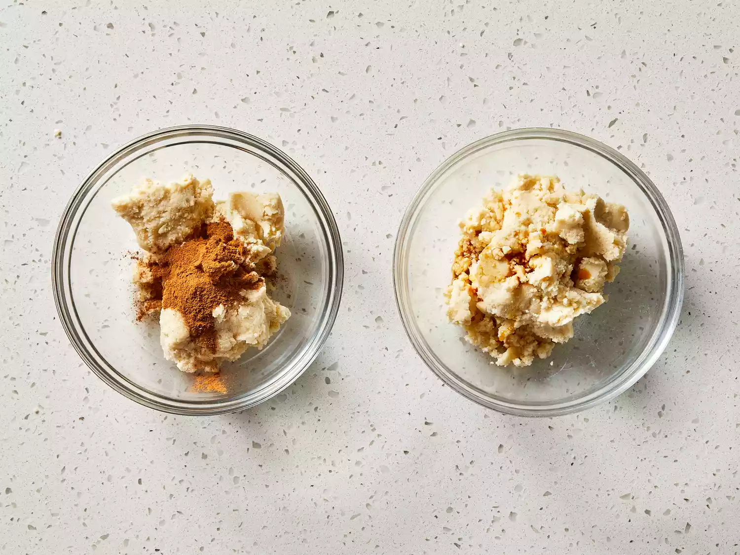 Dough divided into separate bowls, with cinnamon mixed in one and vanilla in the other.