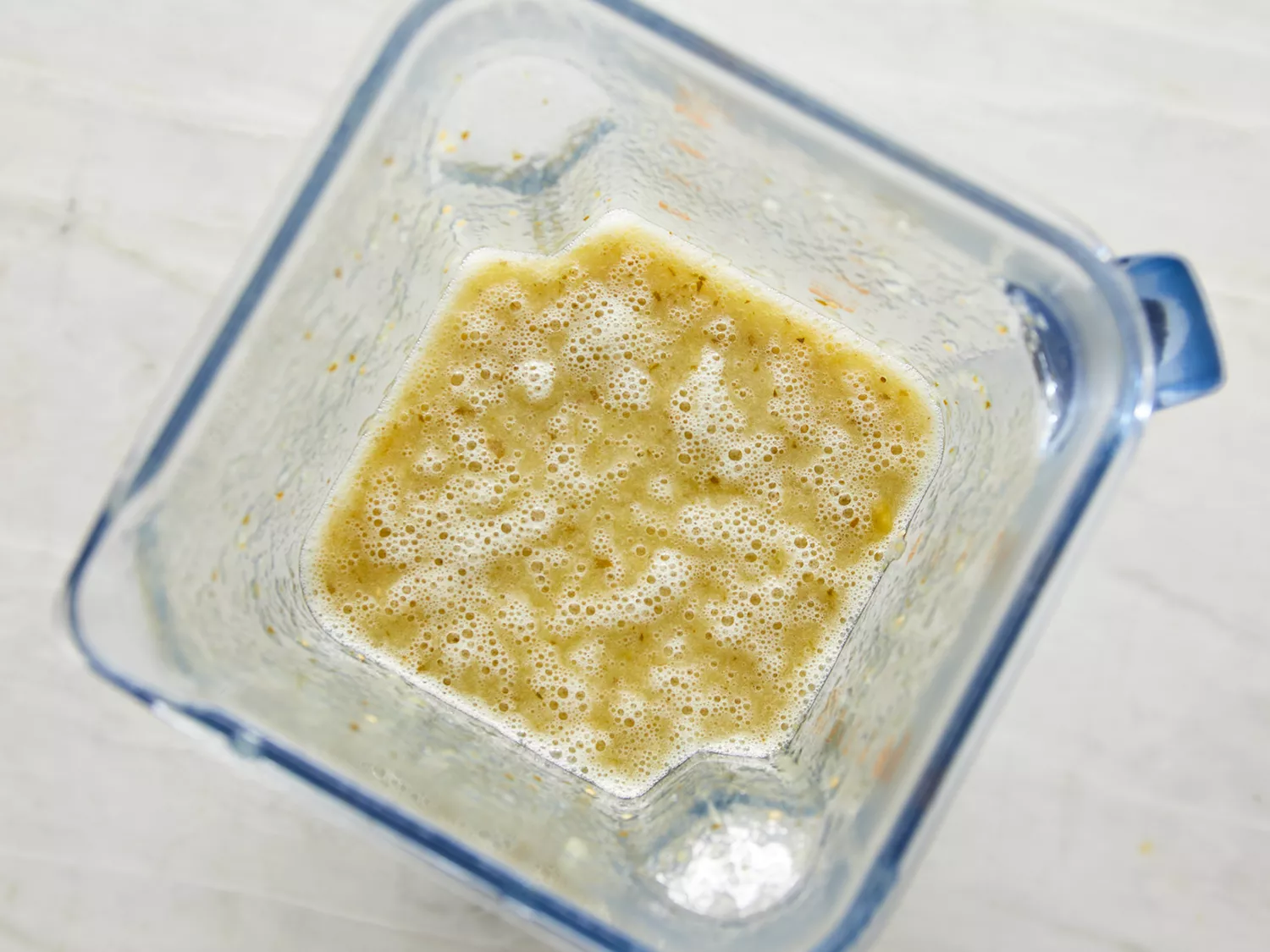 Overhead shot of tomatillo salsa verde being blended