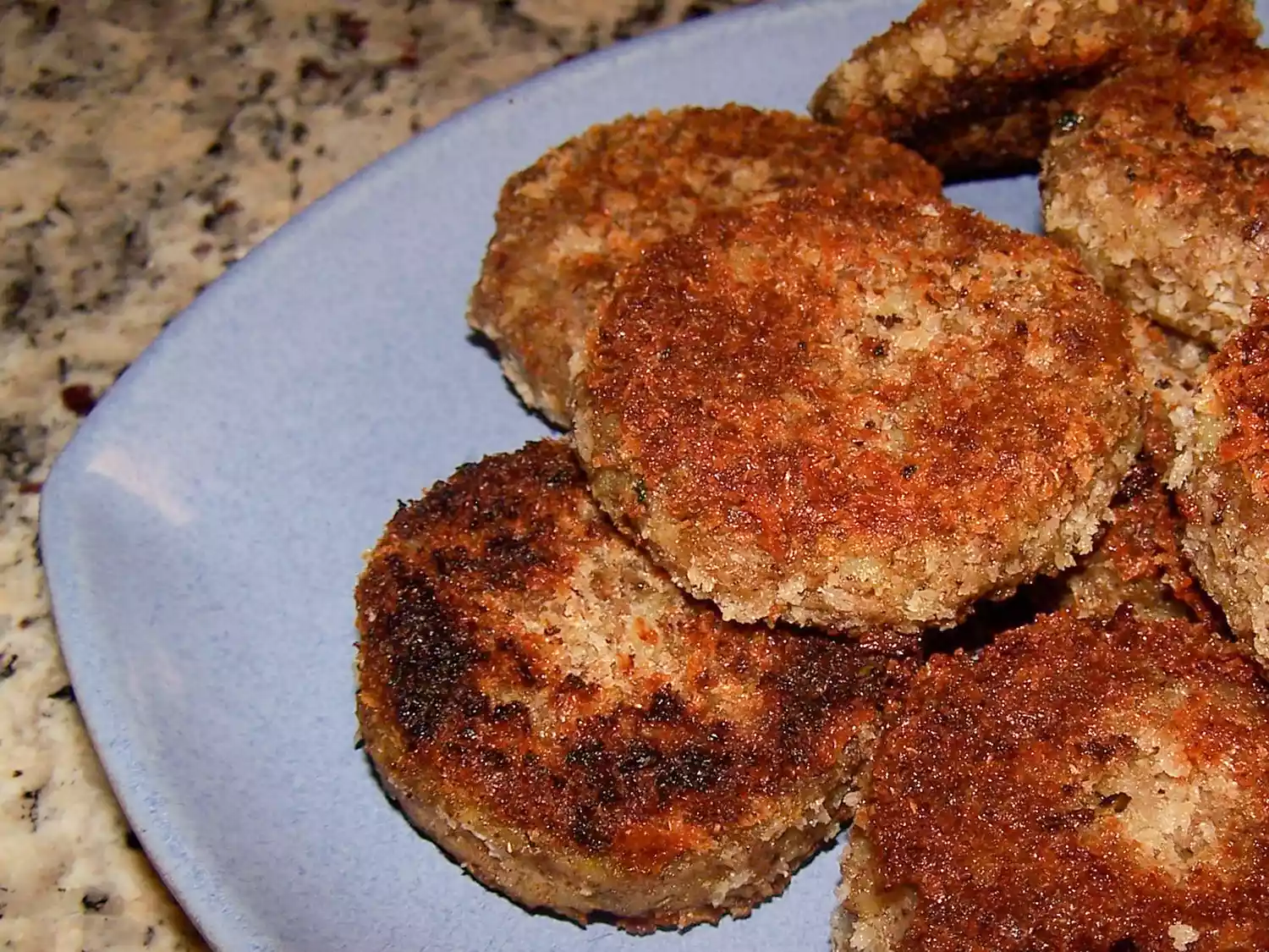 Close up view of potato cutlets on a blue plate