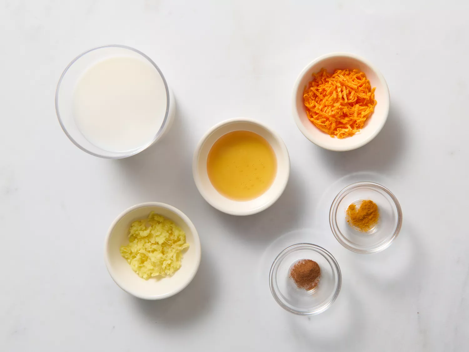 Ingredients for turmeric latte, including milk, ginger, and spices.