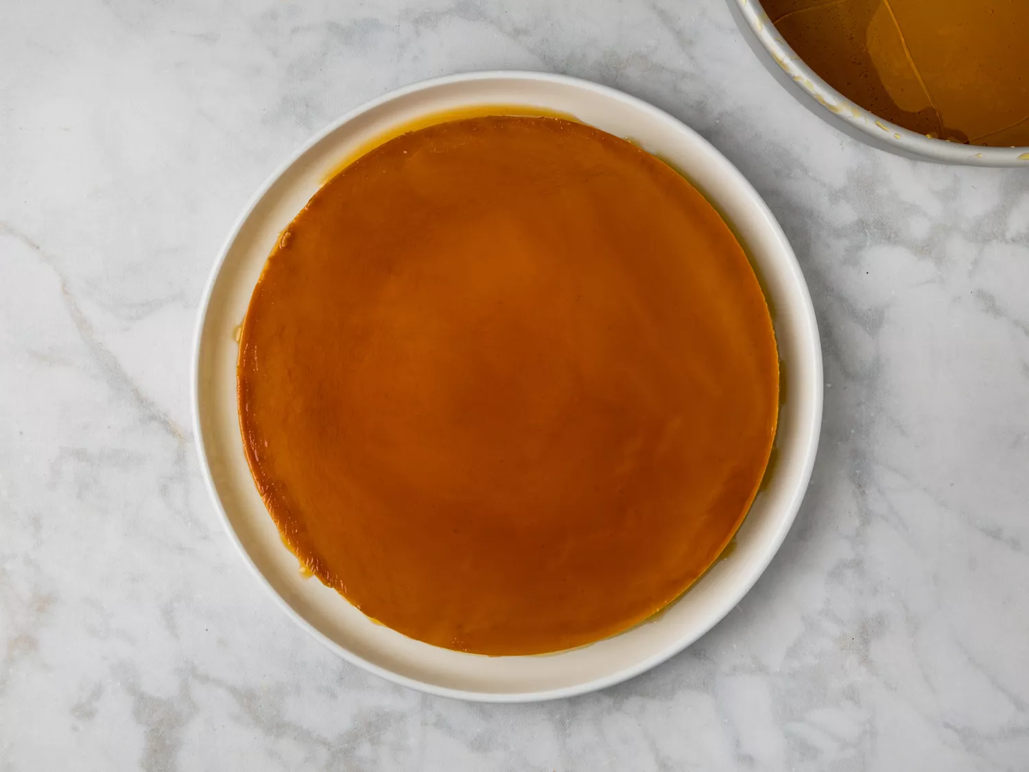 Fully baked and unmolded flan with a glossy caramel top.