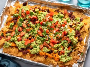 Loaded nachos with guacamole, beans, and fresh toppings.