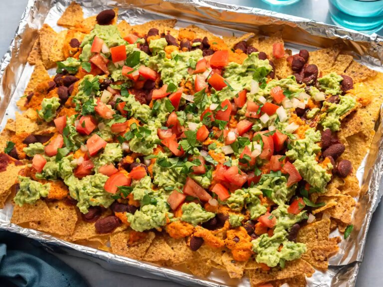 Loaded nachos with guacamole, beans, and fresh toppings.