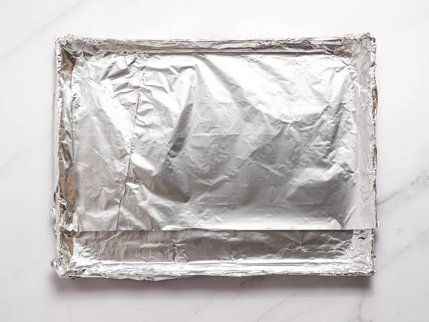 Baking tray lined with aluminum foil.