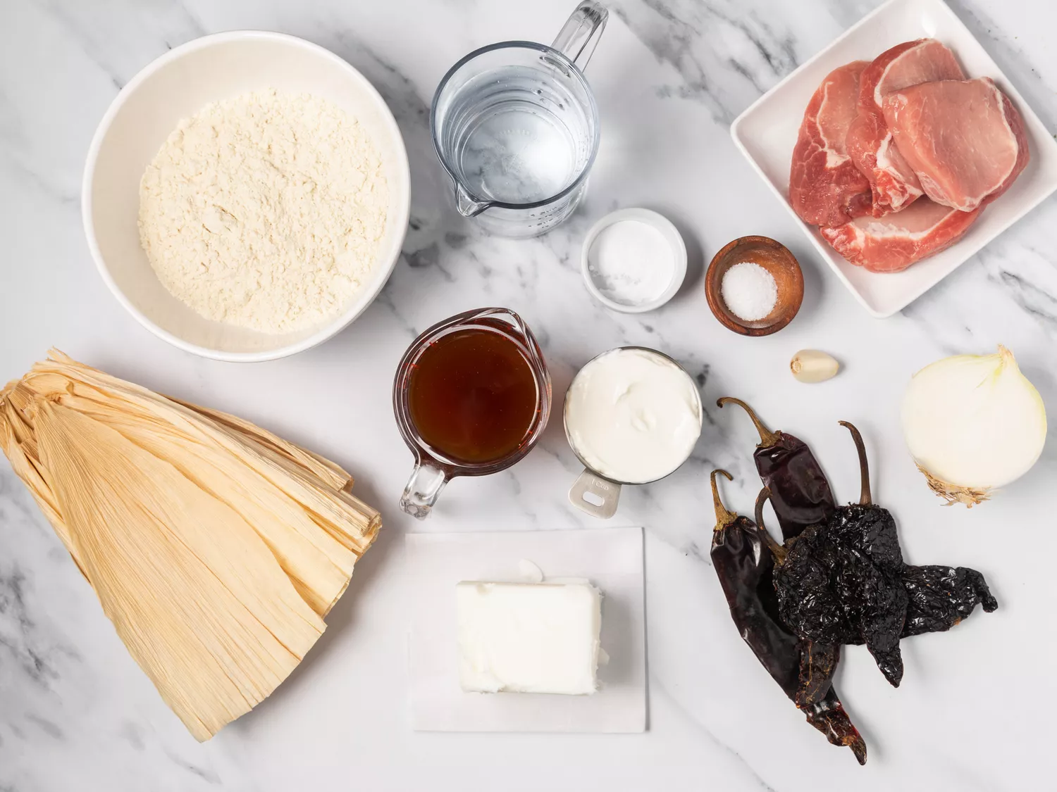 Various bowls filled with ingredients to make homemade tamales.