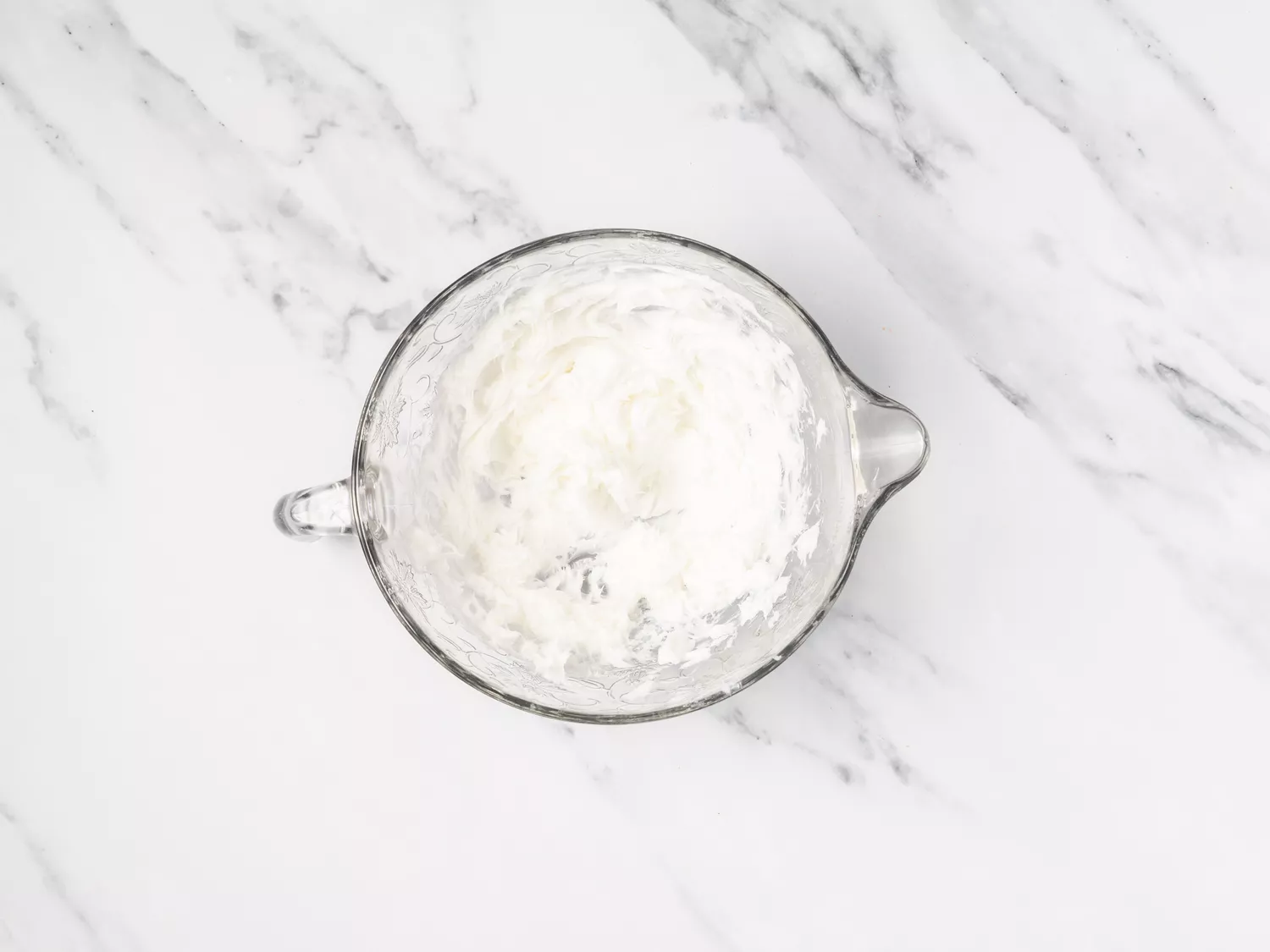 Whipped lard in a glass bowl.
