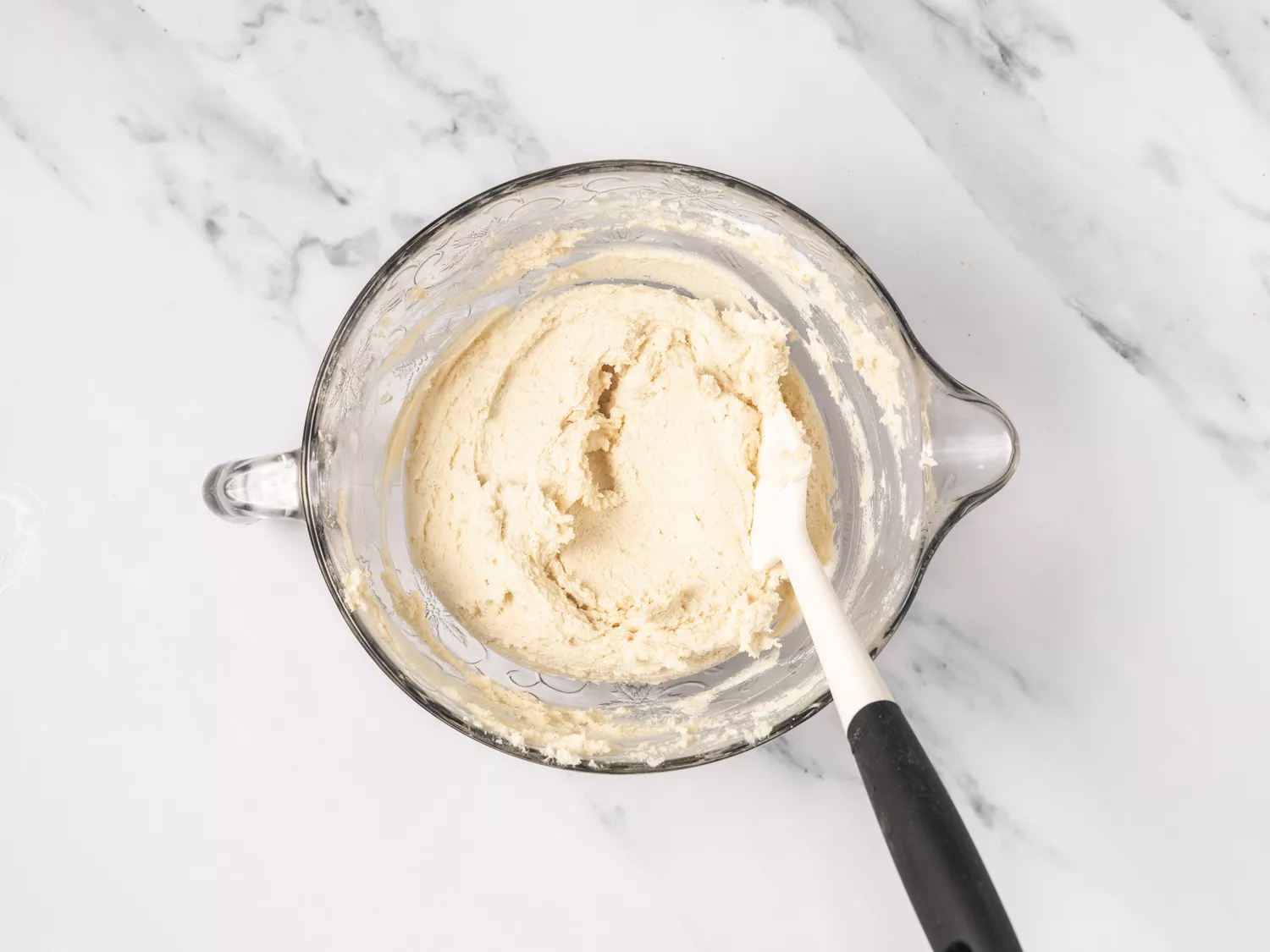 Tamale batter in a glass mixing bowl.