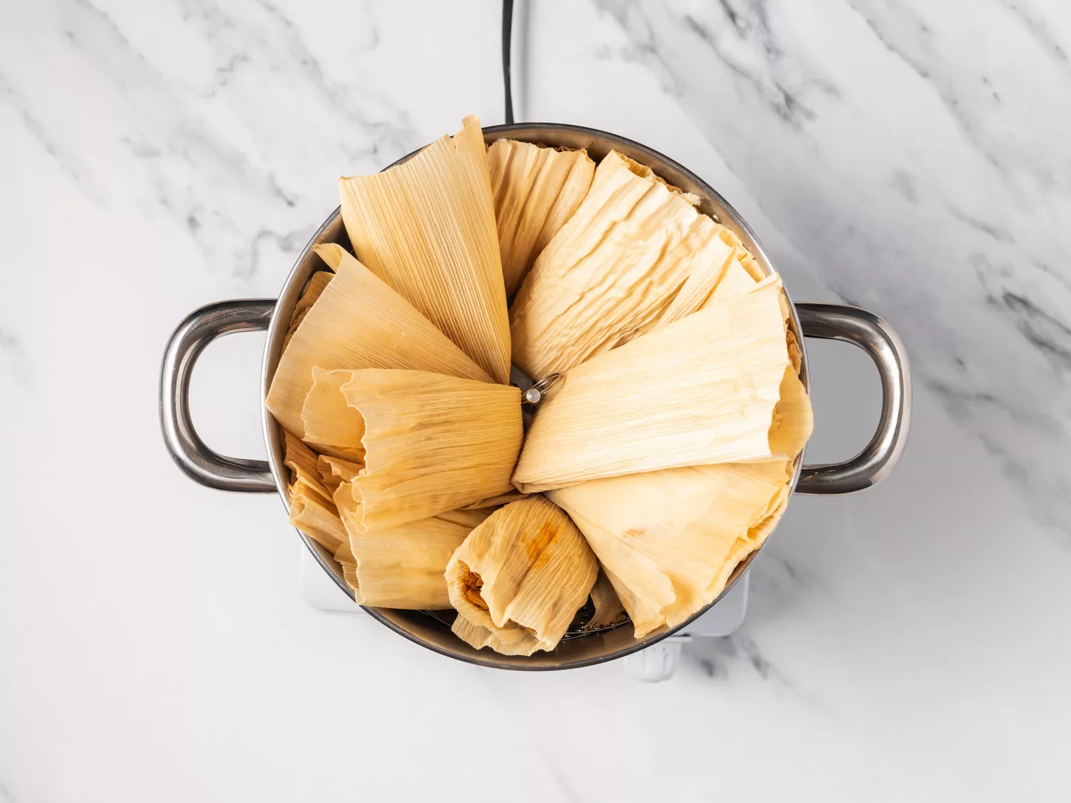 Tamales in a steamer pot. 