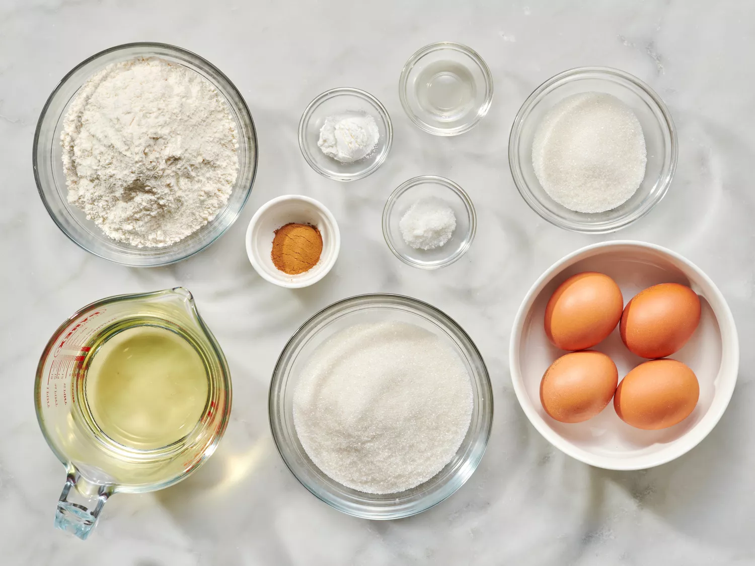Ingredients for buñuelos, including flour, eggs, and sugar.