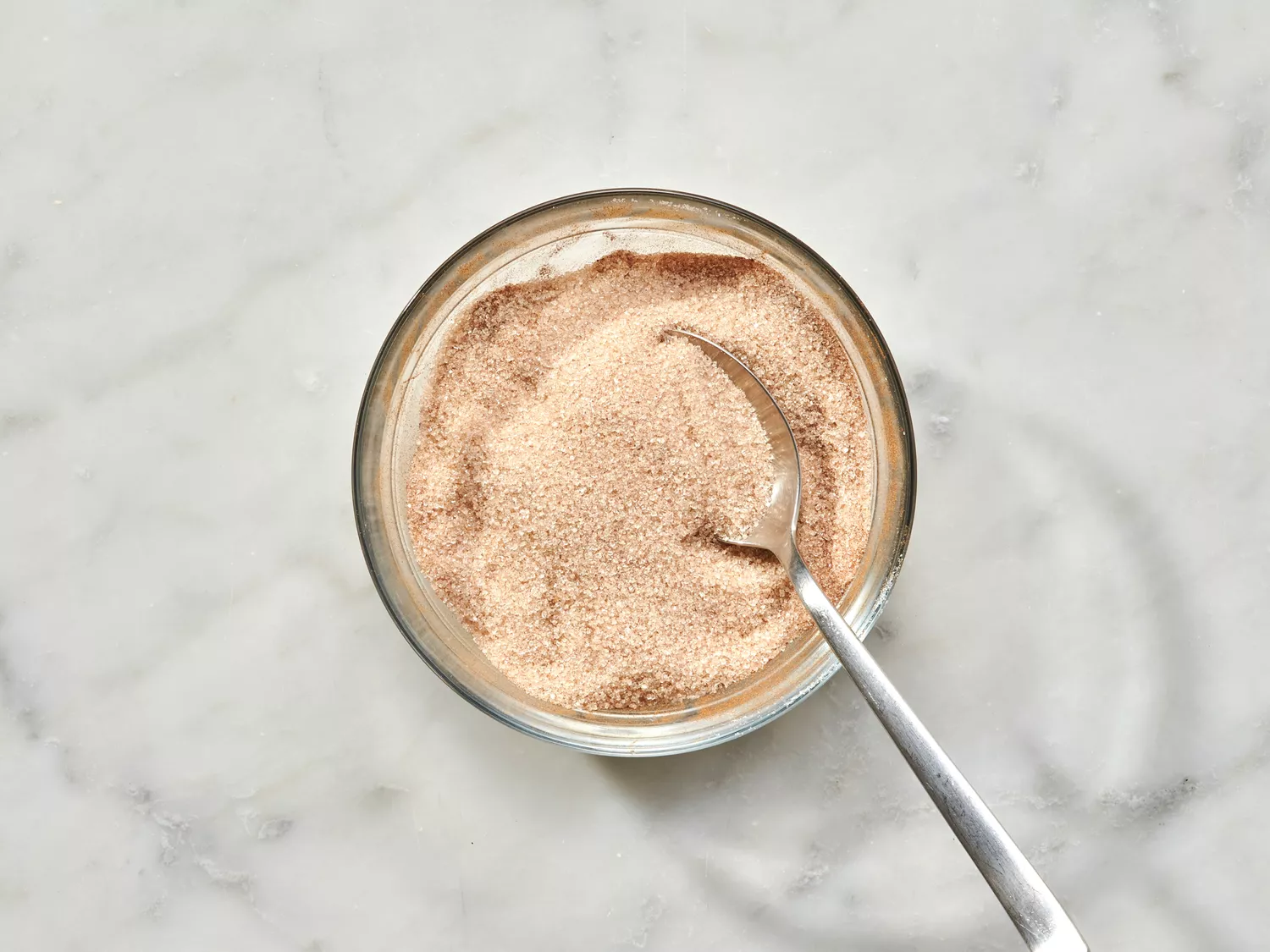Cinnamon sugar mixture in a bowl with a spoon.