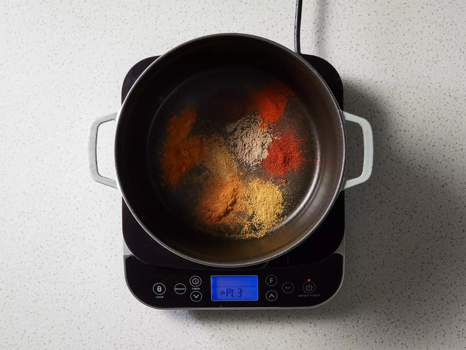 A large pot with spices toasting