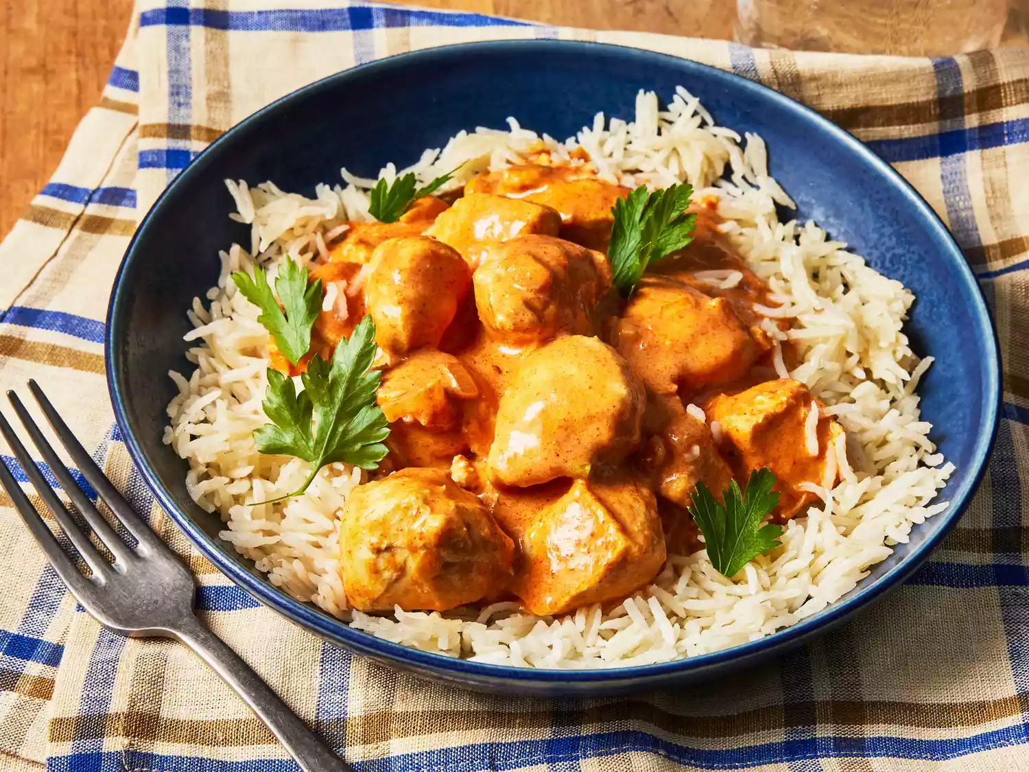 A bowl of curry stand chicken tikka masala served over rice