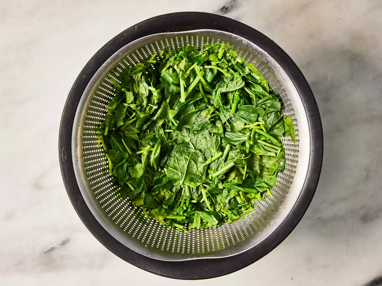 A colander of boiled spinach