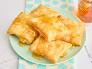 A plate of sopapillas drizzled with honey