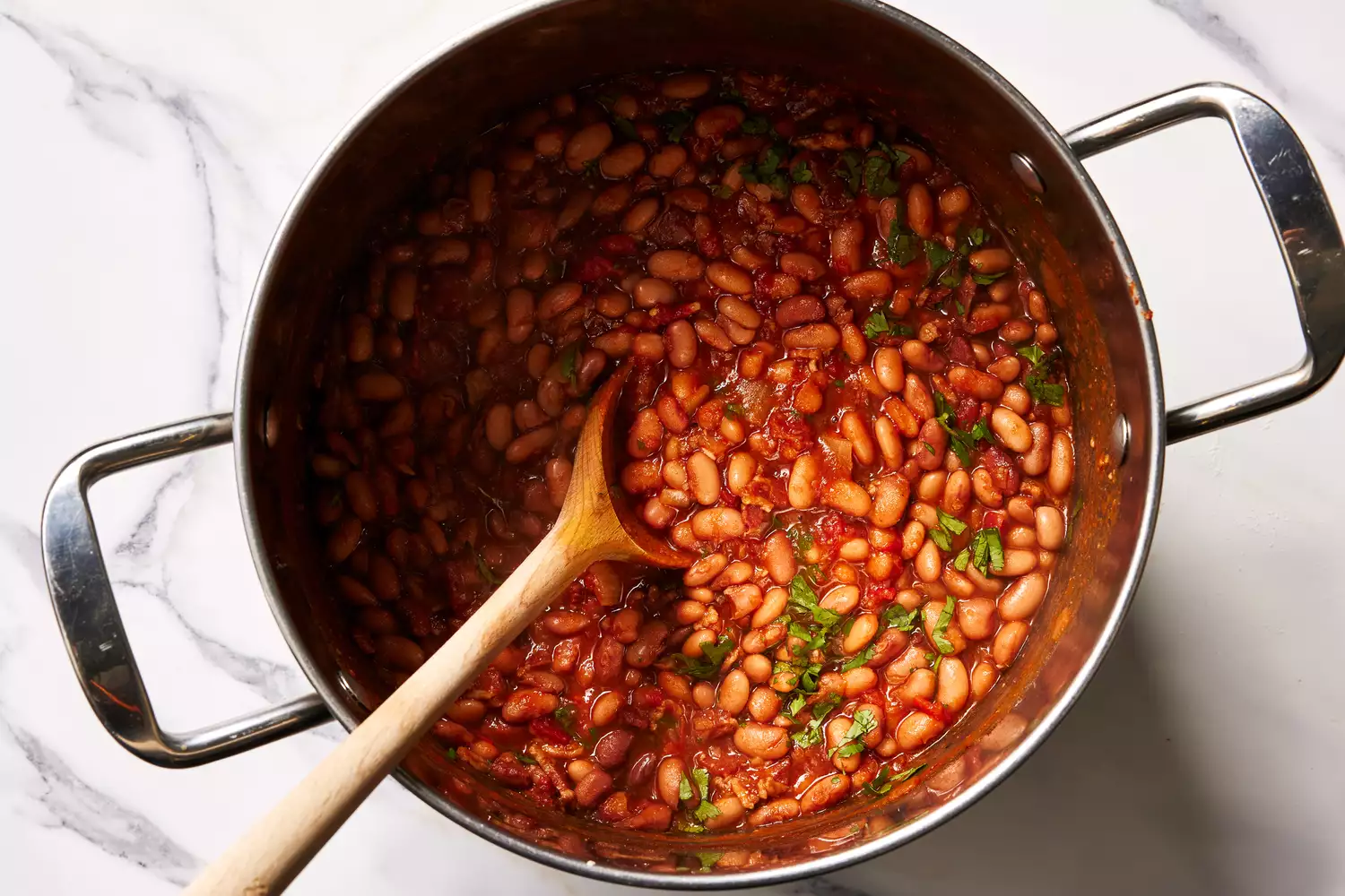 A large pot of pinto beans with Mexican-style seasoning, with chopped cilantro