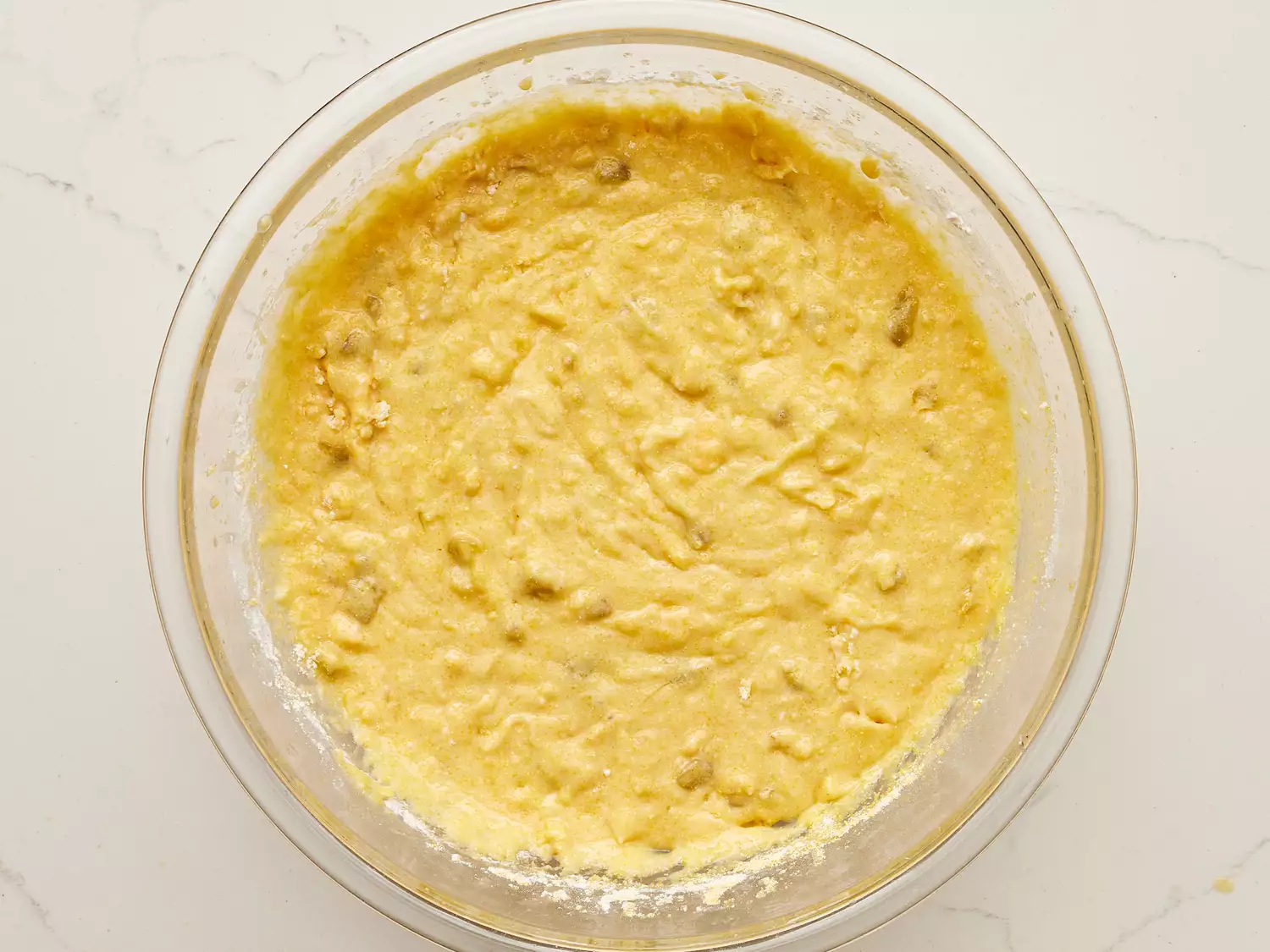 A glass bowl with Mexican cornbread batter