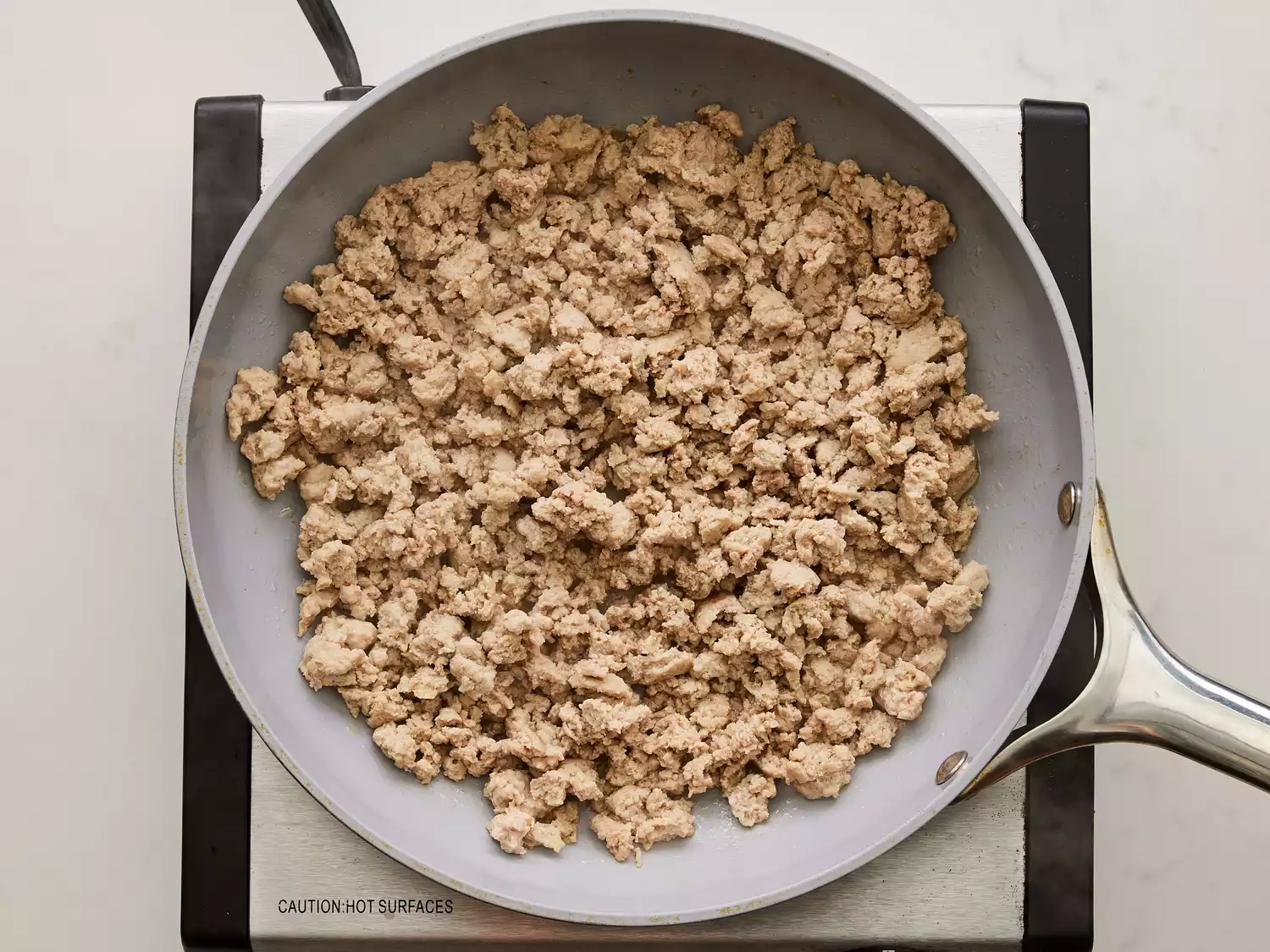 A large pan with cooked ground turkey