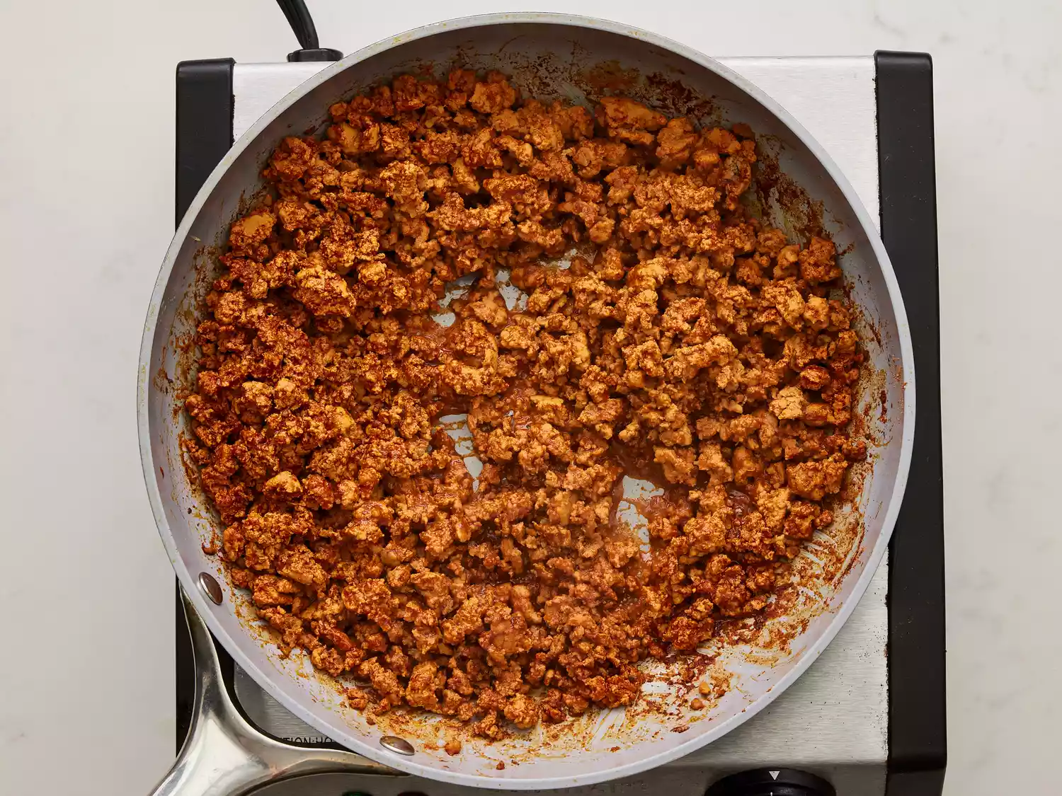 A large pan of cooked ground turkey taco meat