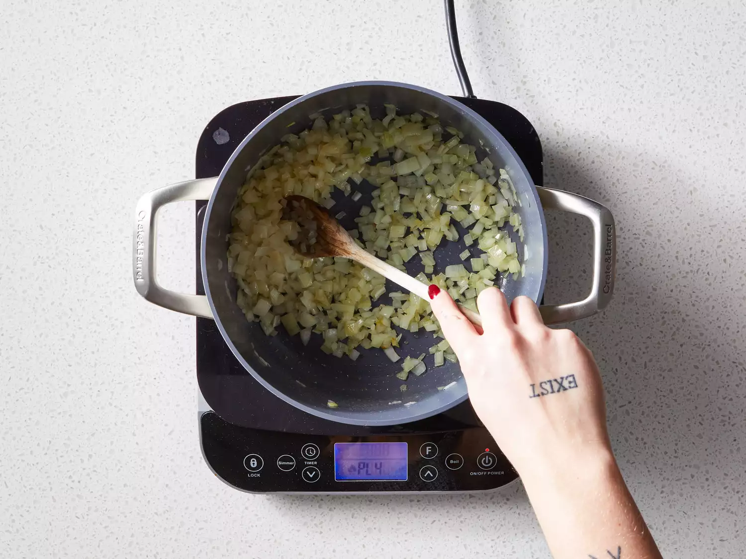 A pot of chopped onion cooking in oil