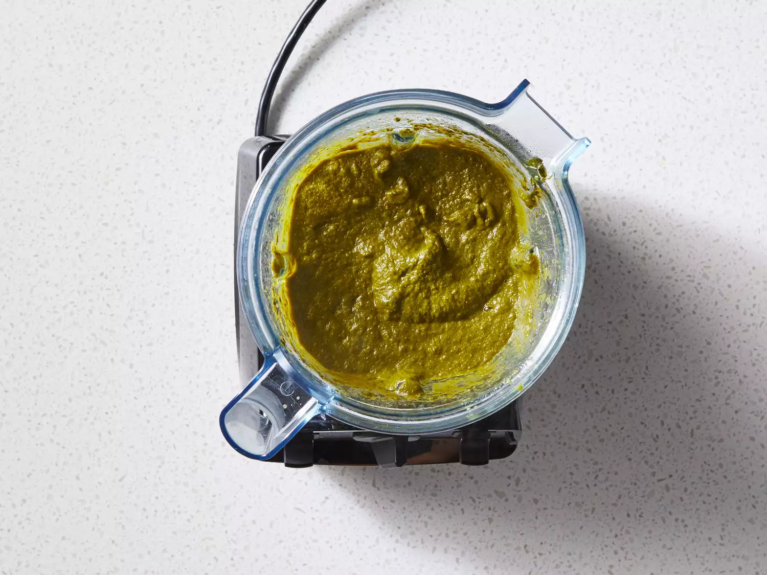 A blender with smooth spinach mixture