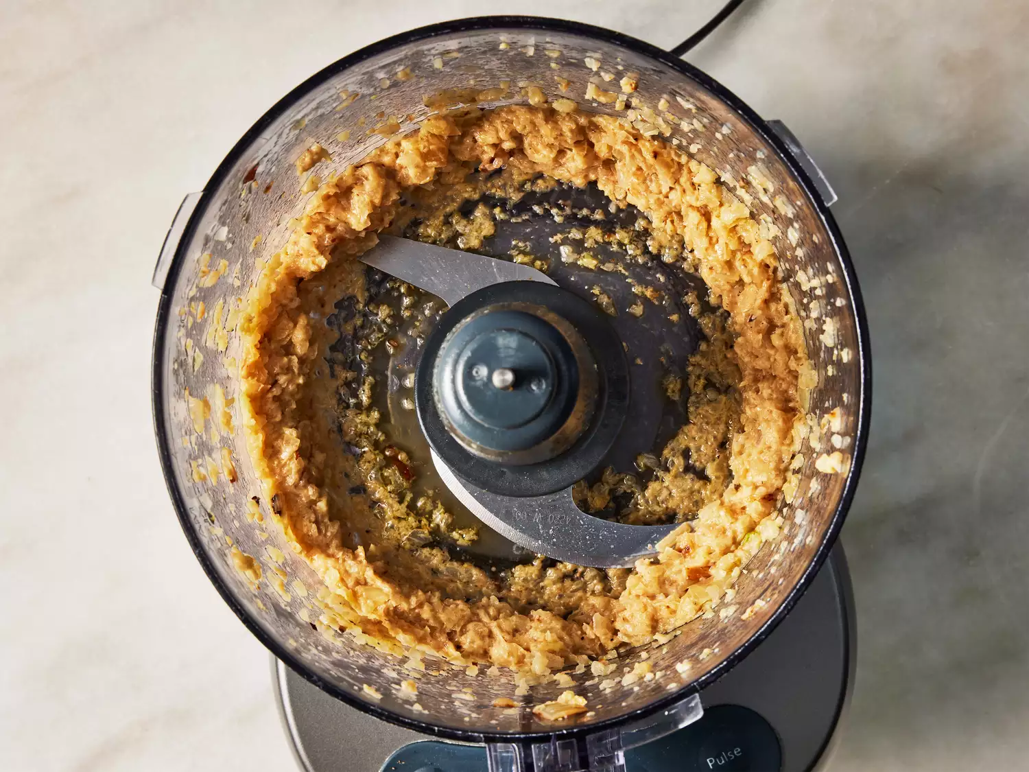 A food processor with processed cooked onions