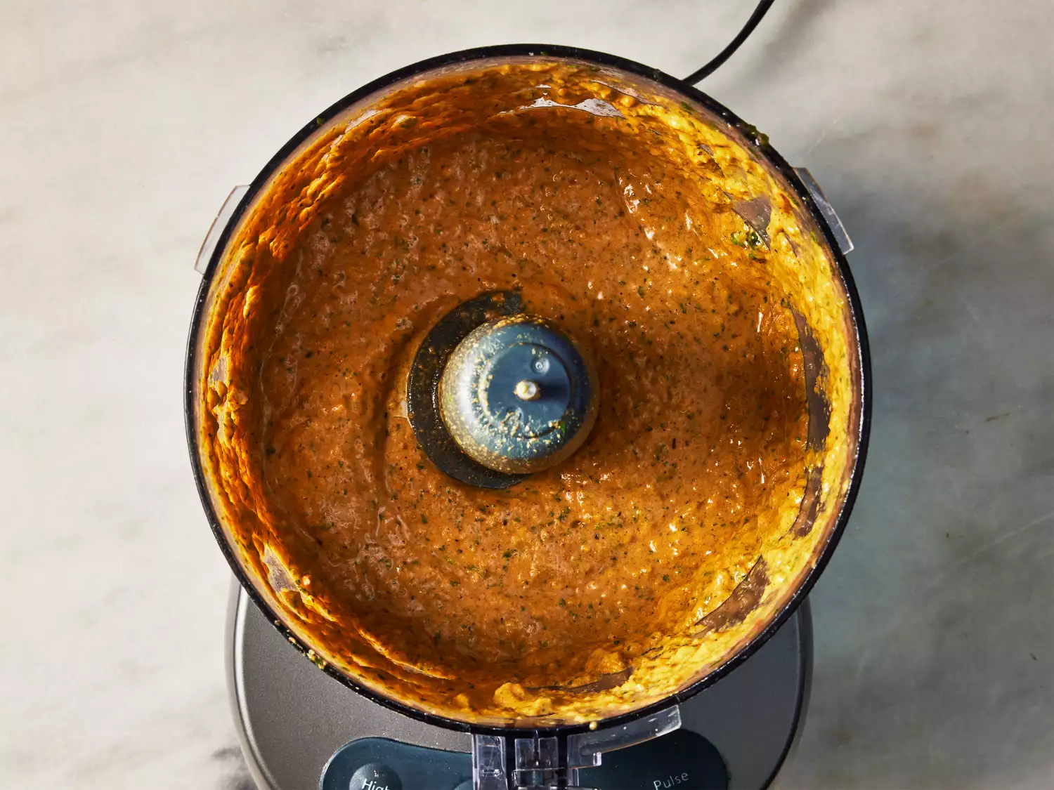 A food processor with processed curried yogurt sauce