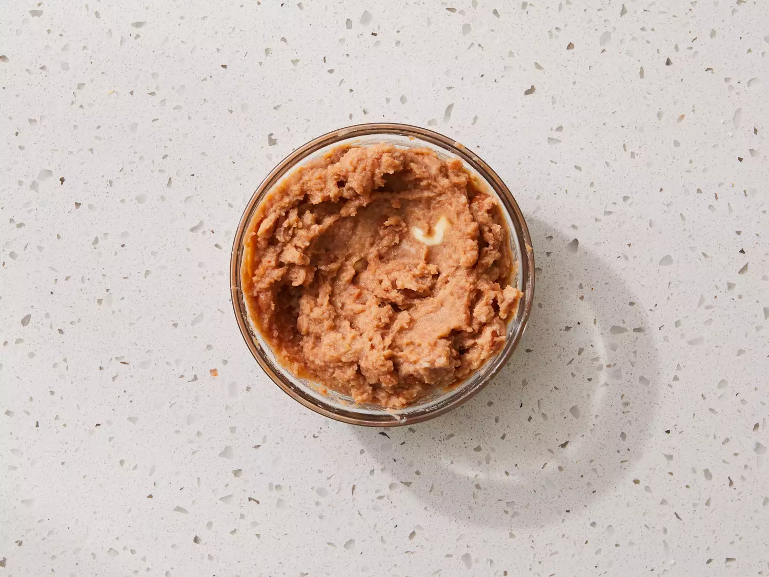 A small bowl of warmed refried beans