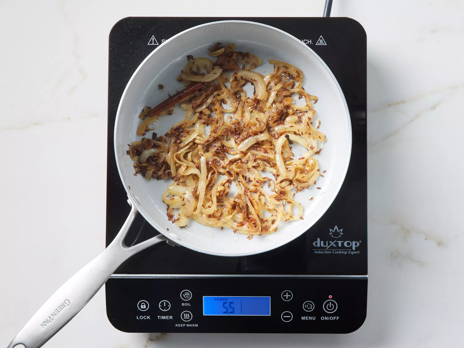 A pot of caramelized onions and toasted spices