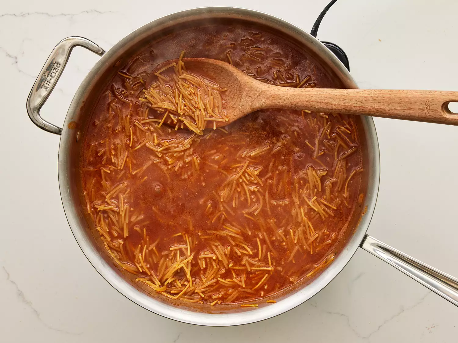 A pan of cooked Fideo pasta in tomato sauce