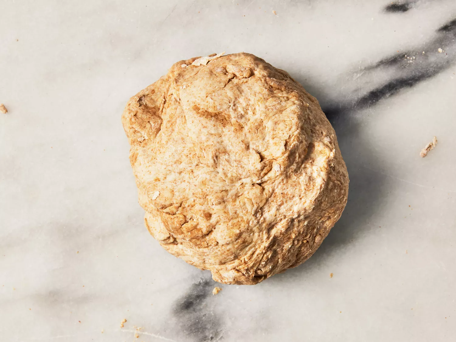 A ball of dough on a marble surface