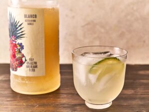 Freezer margarita in glass garnished with lime slice and ice