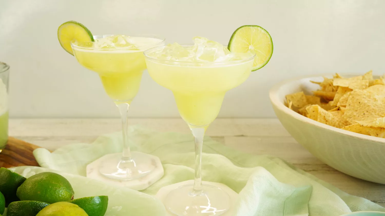 Two Whole Lime Margaritas over ice with lime wedge garnishes