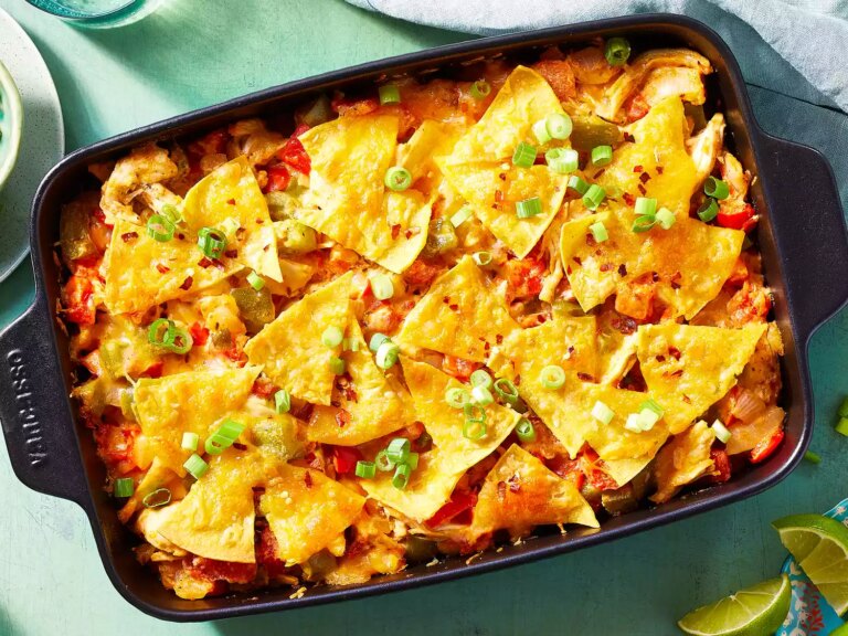 Looking down at a casserole dish of king ranch chicken and fresh veggie casserole