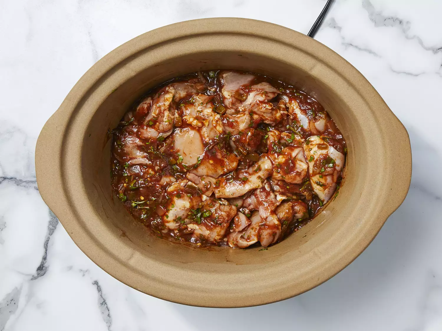 chicken placed in slow cooker with seasonings 