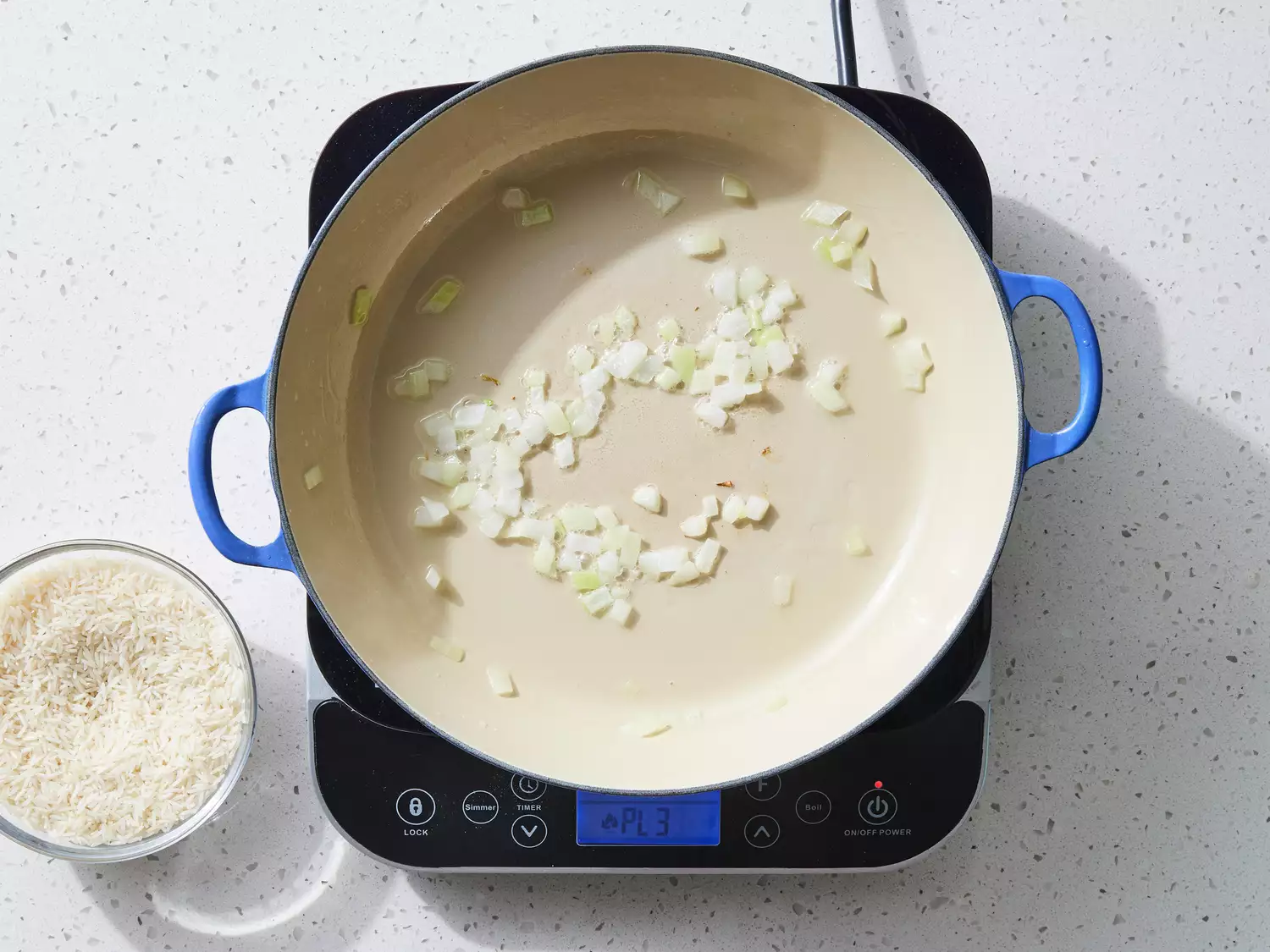 A large pot with chopped onion cooking in oil
