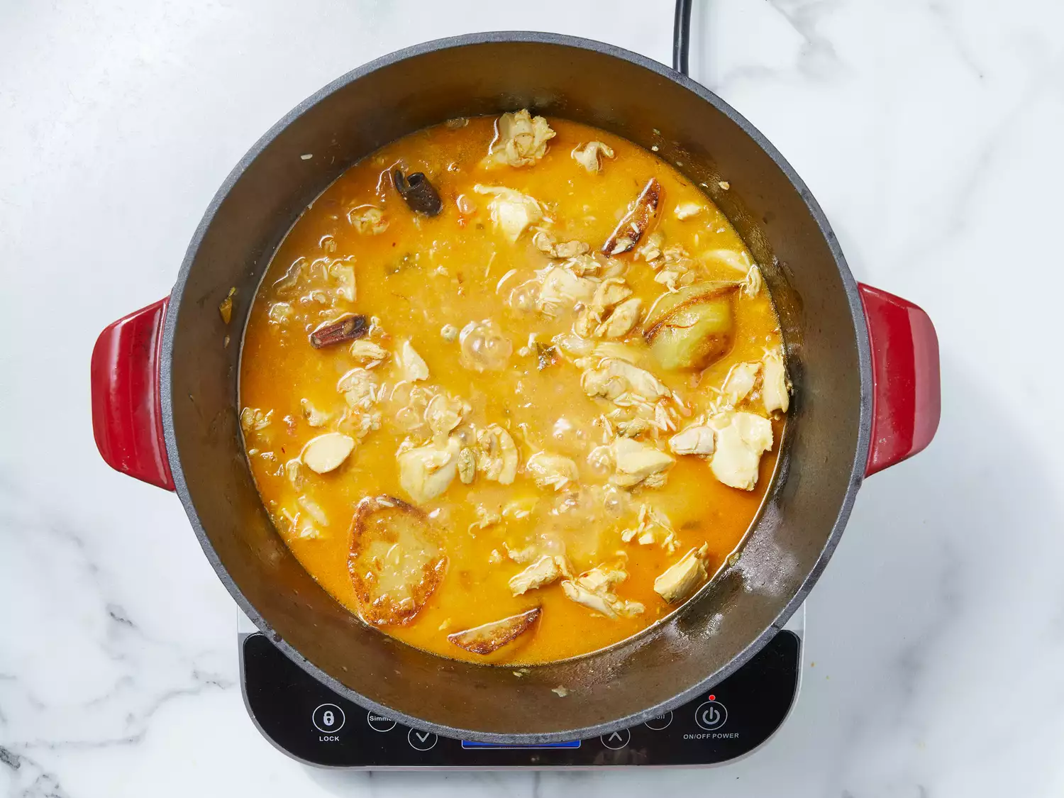 chicken mixture and potatoes added into the pot, stirring to combine and coming to a boil.