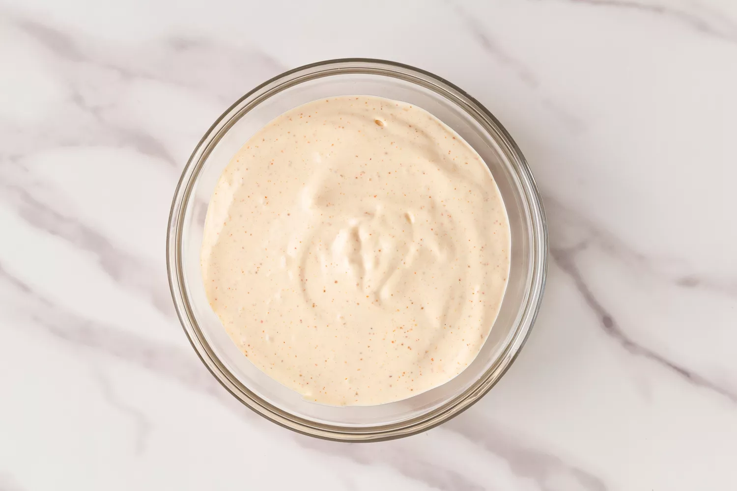 Mayonnaise sauce in a glass bowl. 