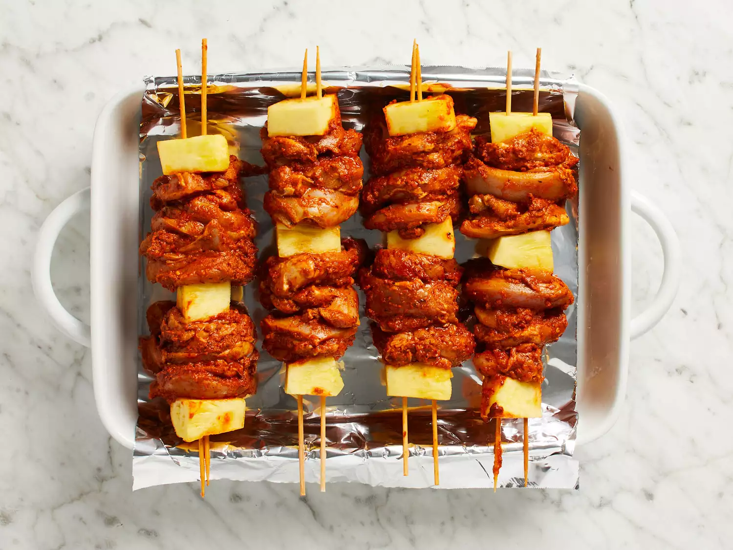 chicken pineapple skewers in pan